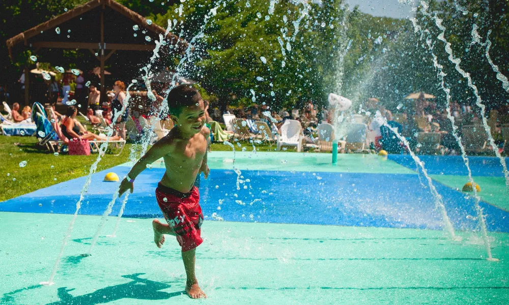 Child running through spray ground at Minerals Hotel