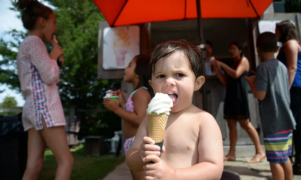 Young boy eating vanilla ice cream cone by the pool at Minerals Hotel in NJ