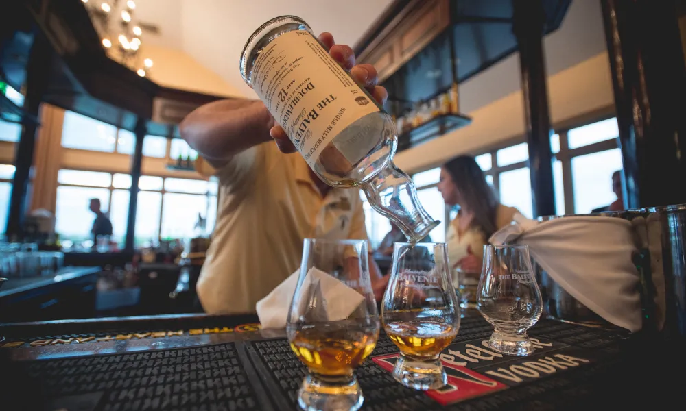 Bartender pouring whiskey at Owen's Pub