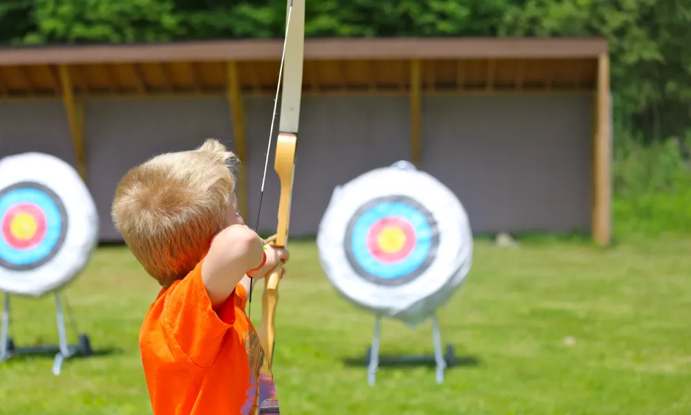 Boy doing archery target practice 