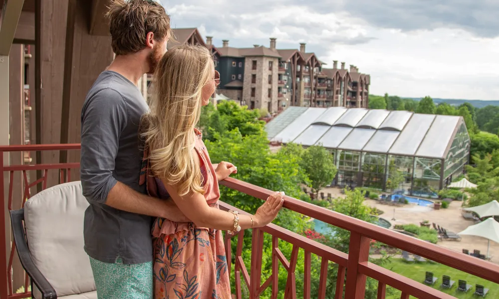 Couple enjoying breakfast while overlooking their balcony view from Grand Cascades Lodge