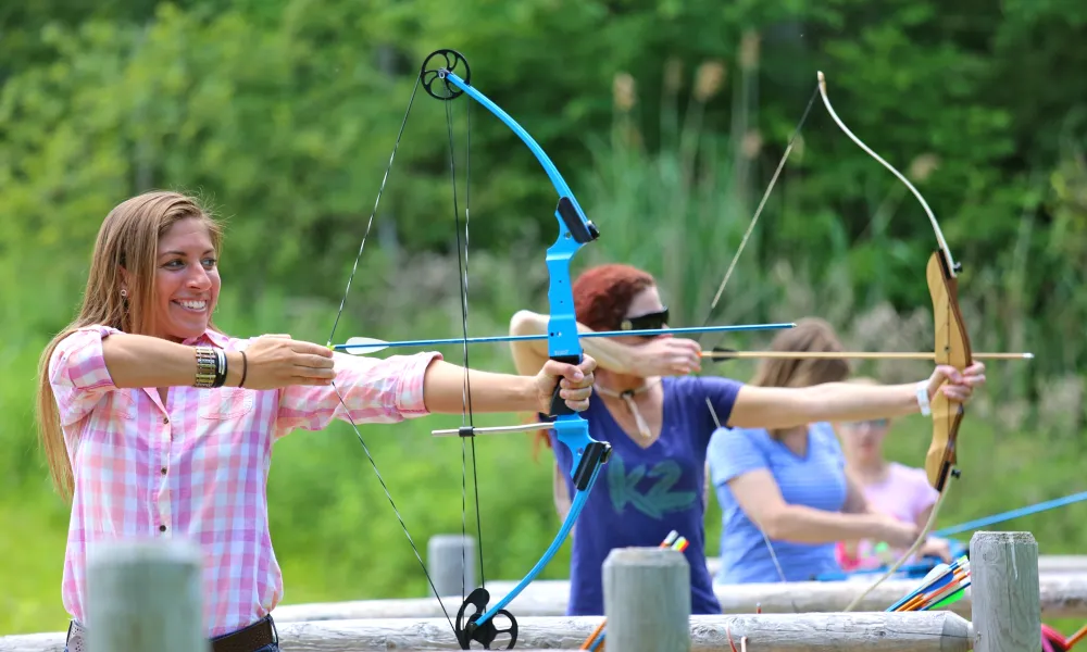 Group of people doing archery practice.