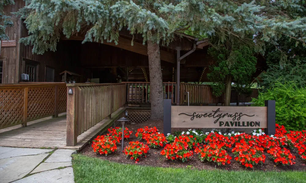 Sweetgrass Pavillion entrance with red flowers