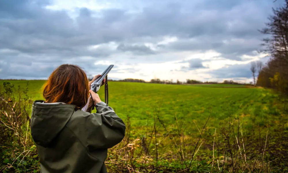 Woman pointing laser gun towards the sky.