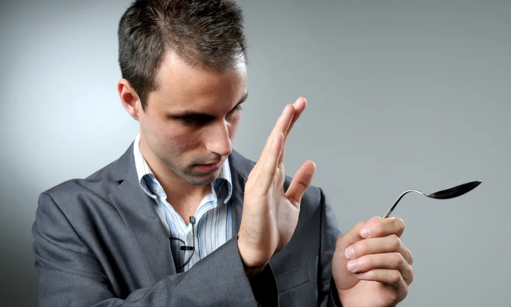 Jesse Dameron holding a bent spoon.