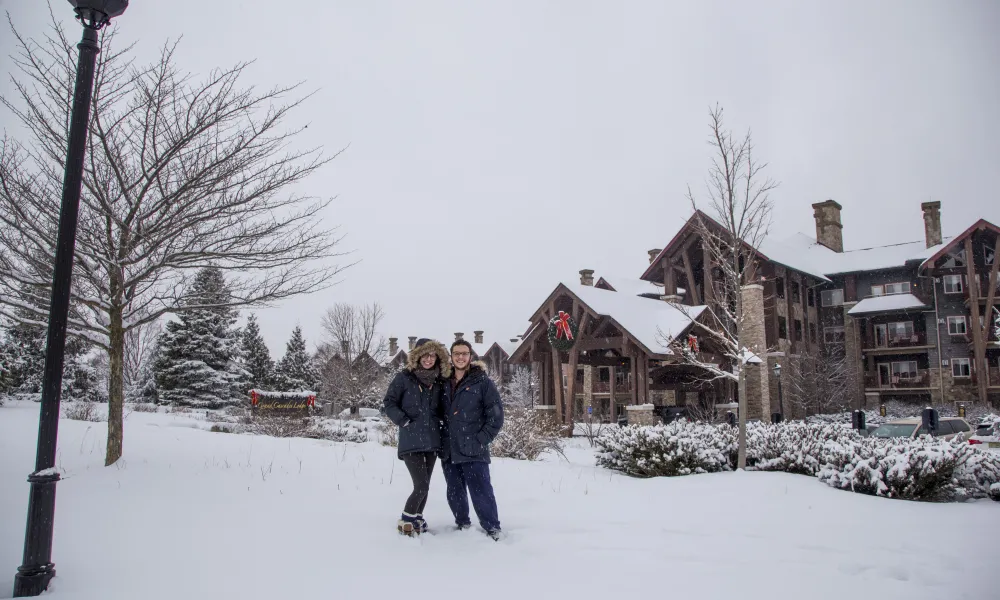 Couple on a snowy day at Grand Cascades Lodge