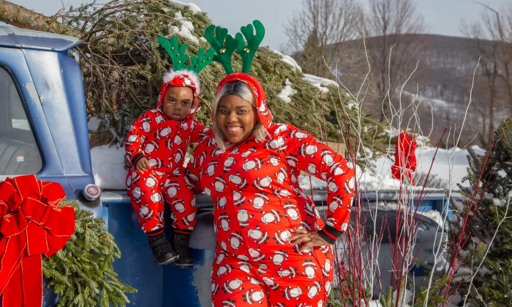 Mother and son in matching Christmas onesies at Grand Cascades Lodge