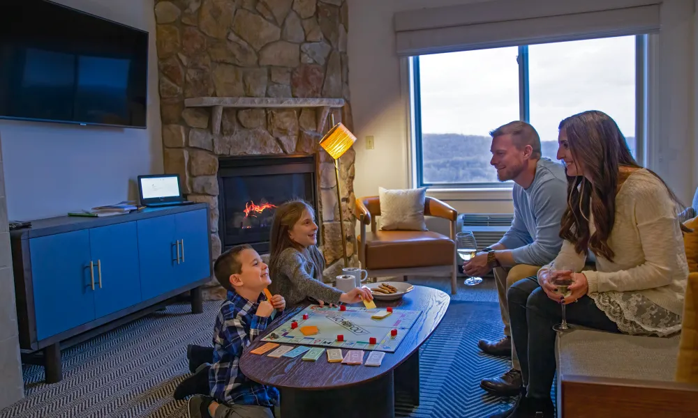 Family playing board game in Grand Cascades Lodge suite