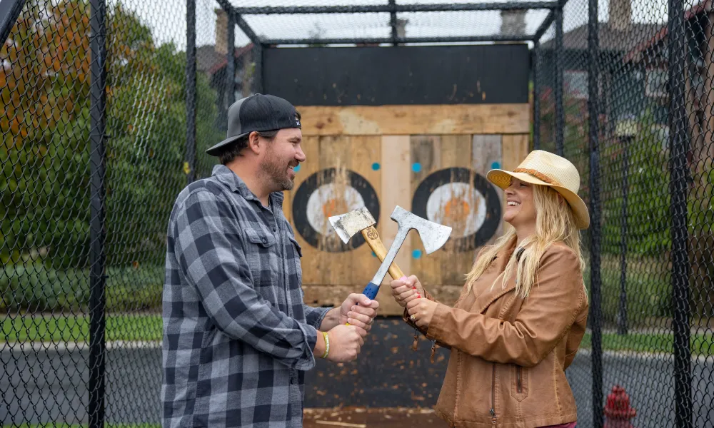 Couple doing axe throwing.