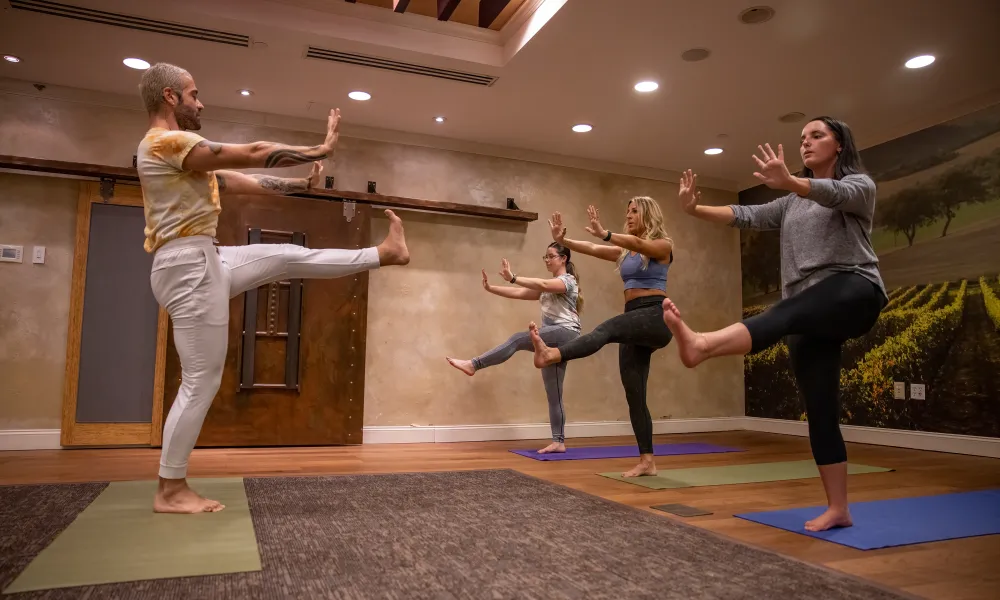 Yoga instructor demonstrating yoga poses to a class at a resort near NYC.