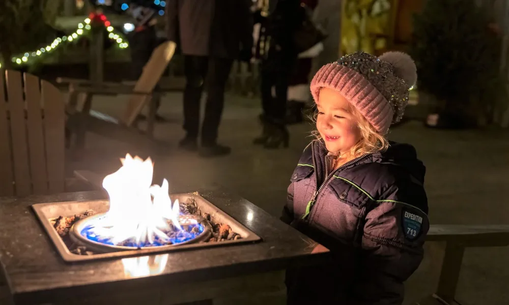 Young girl in front of fire at Frosty's Cantina