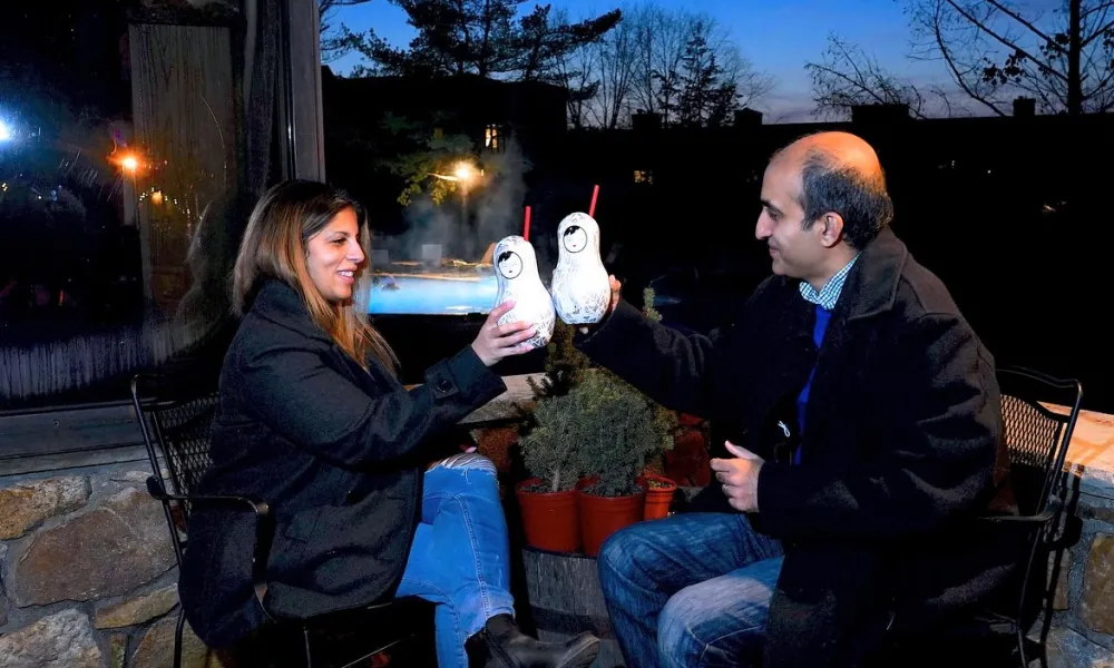 Couple toasting festive cocktails at Frosty's Cantina