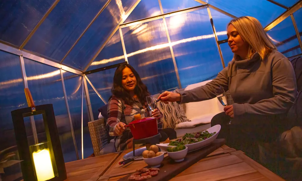 Girlfriends enjoying fondue in Champagne Chalets