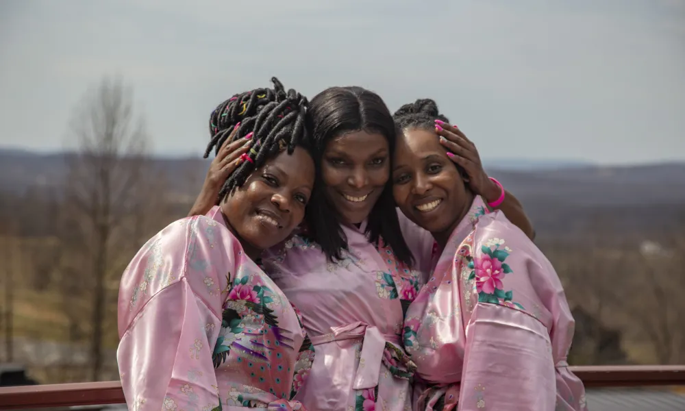 Girlfriends posing with robes