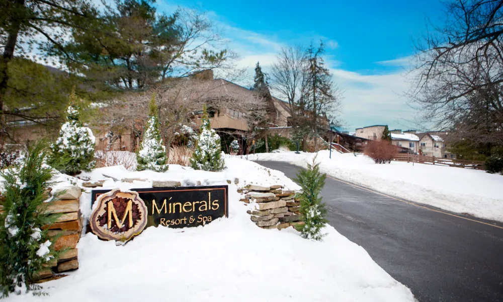 Minerals Resort &amp; Spa sign covered in snow