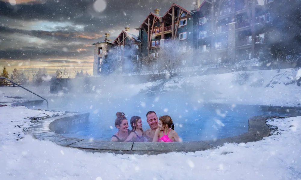 Family enjoying snow pool at Grand Cascades Lodge