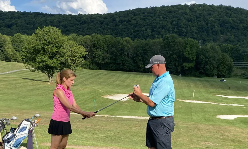 Golf Instructor with Leadbetter Golf Academy teaching woman to golf