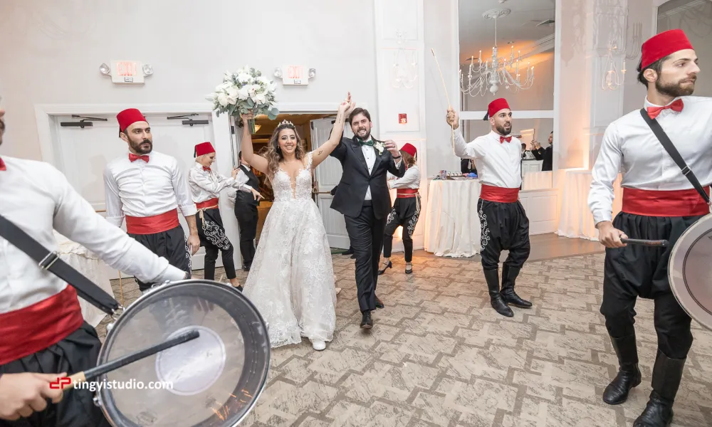 Bride and groom making entrance to wedding reception