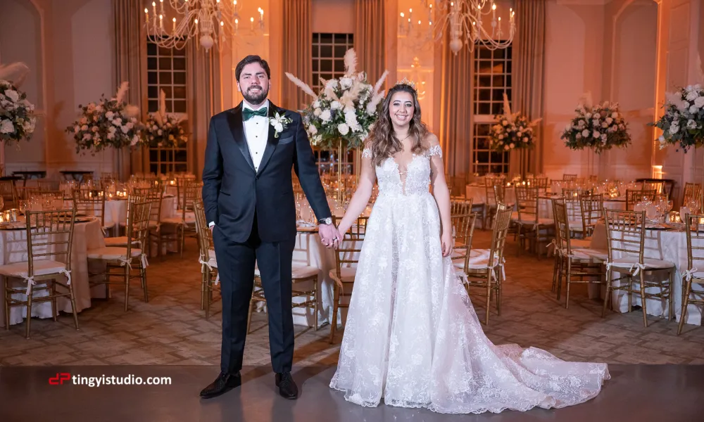 Bride and Groom holding hands in the ballroom at Crystal Springs Resort