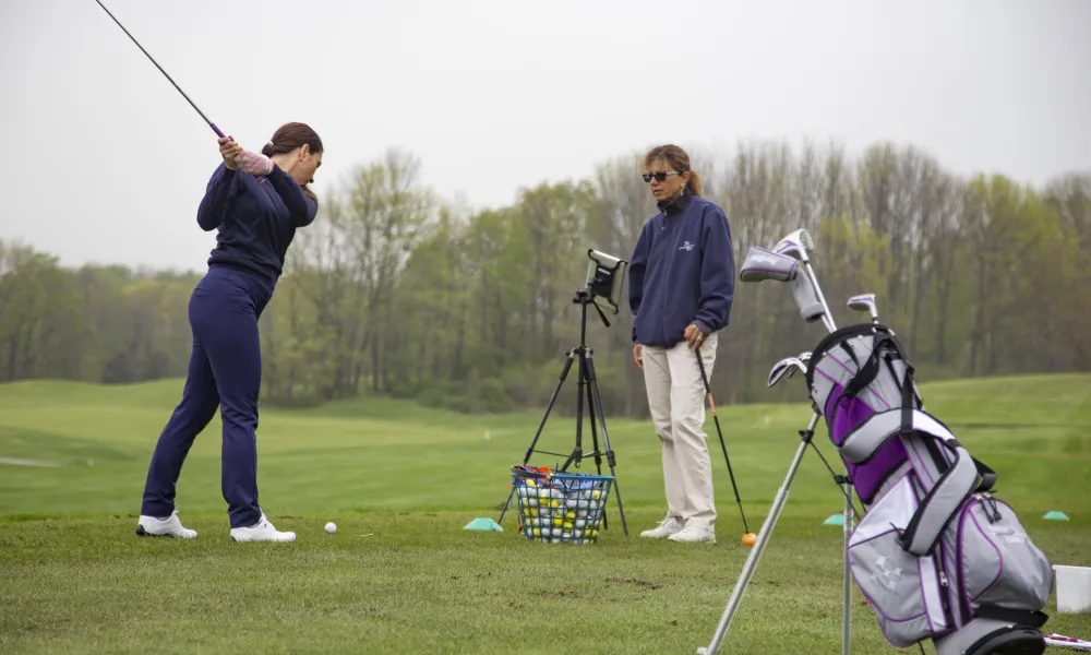 Young girl learning to golf by an instructor at the Leadbetter Golf Academy at Crystal Springs Resort