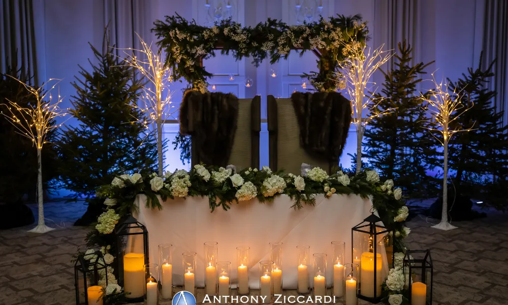 Sweetheart table with throne chairs at ballroom wedding