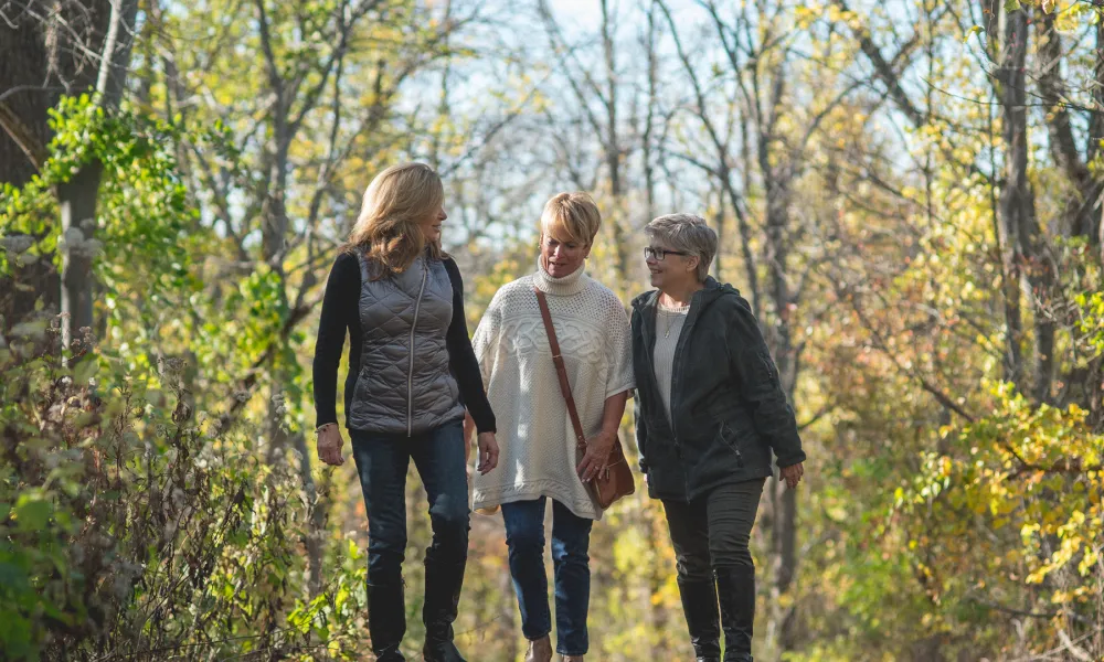 Women walking through a hiking trail in the forest