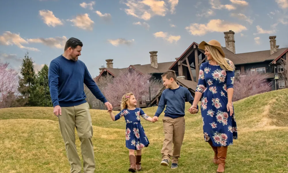 Family of four walking in front of Grand Cascades Lodge