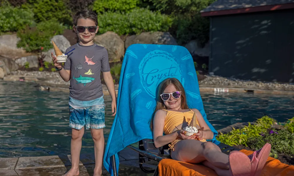 Children enjoying ice cream cones by the pool at Crystal Springs Resort in NJ