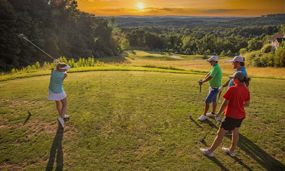 Golfers at sunset on the course of Wild Turkey at Crystal Springs Resort