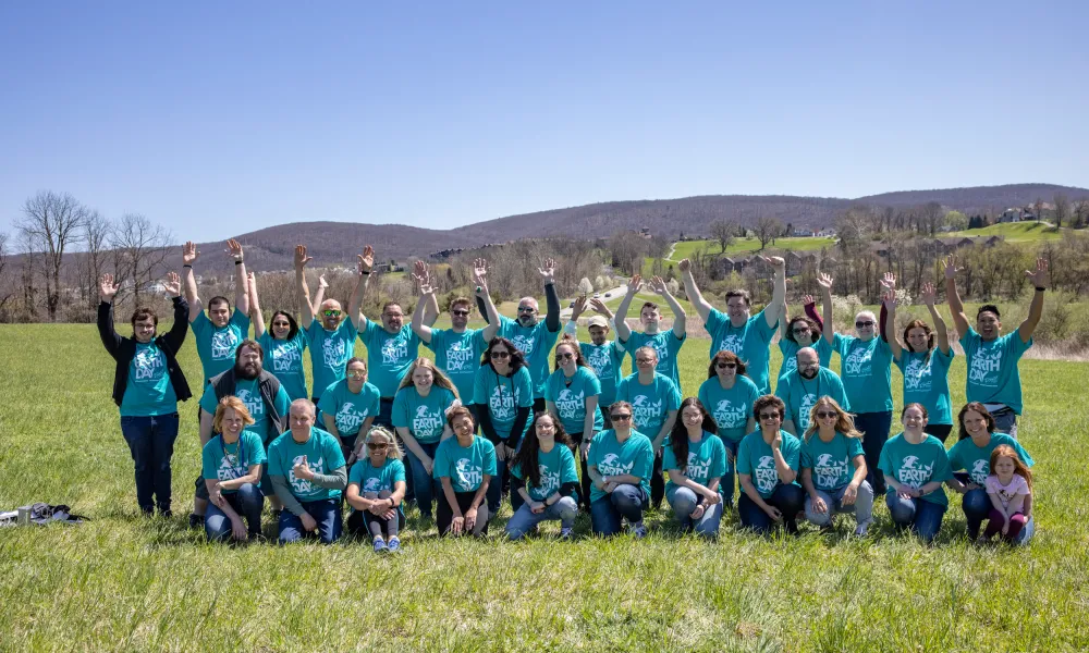 Crystal Springs Resort staff raising hands in group photo