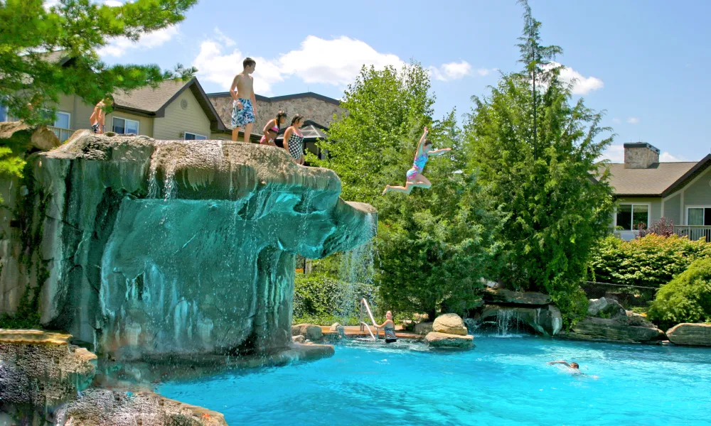 Girl jumping from cliff jump at Minerals Hotel pool