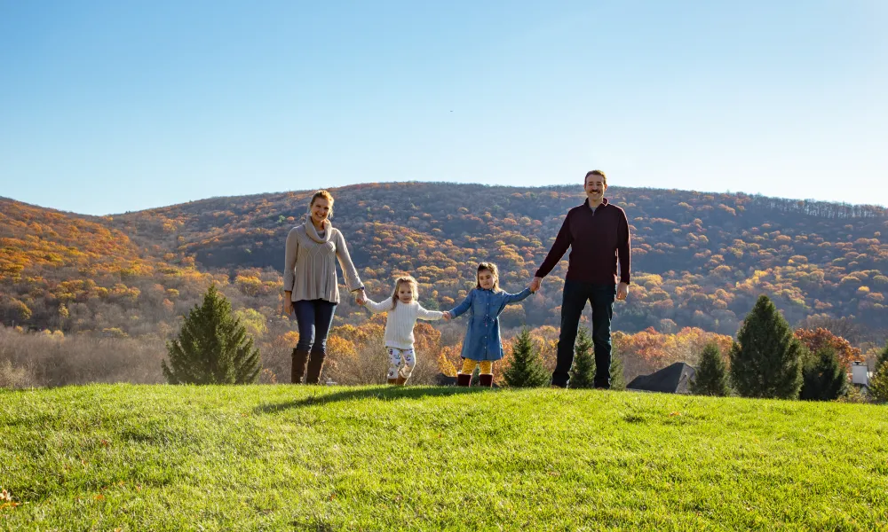 Family holding hands in front of the beautiful mountain view at Crystal Springs Resort