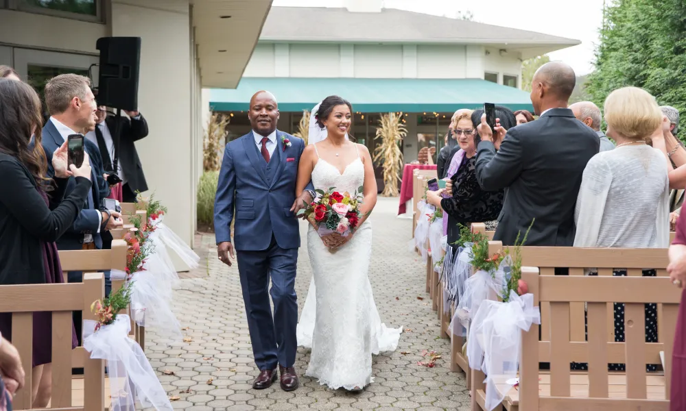 Dad walking the bride down the isle at black bear golf club.