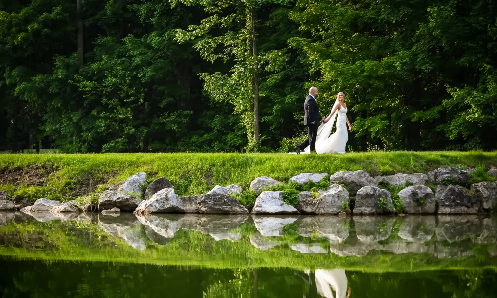 Bride and Groom walking on a golf course.