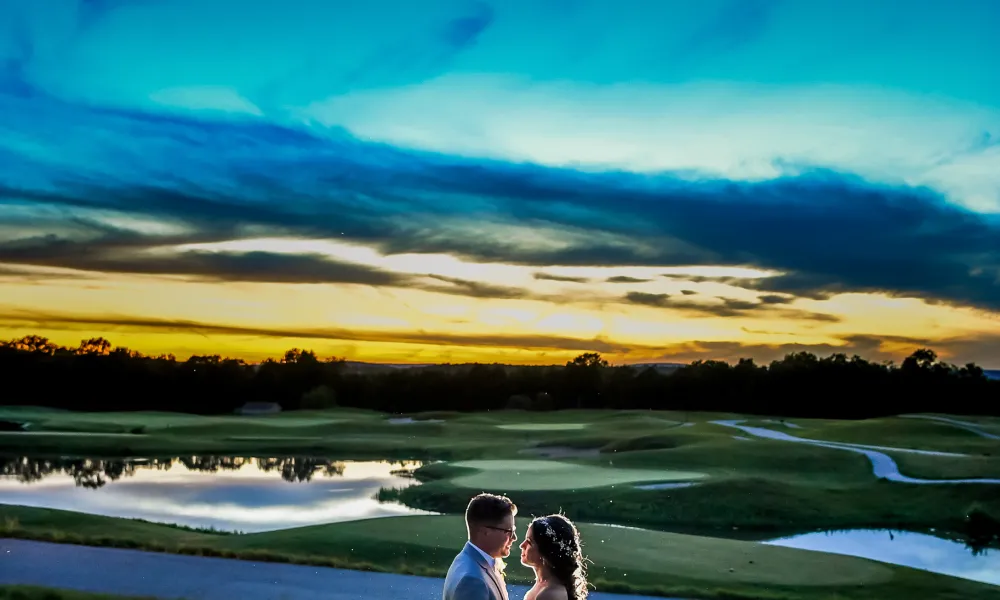 Bride and groom on Ballyowen Golf Course at sunset