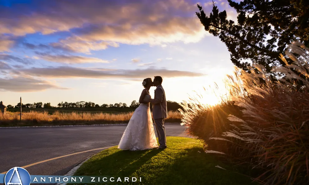 Beautiful wedding couple kissing at sunset