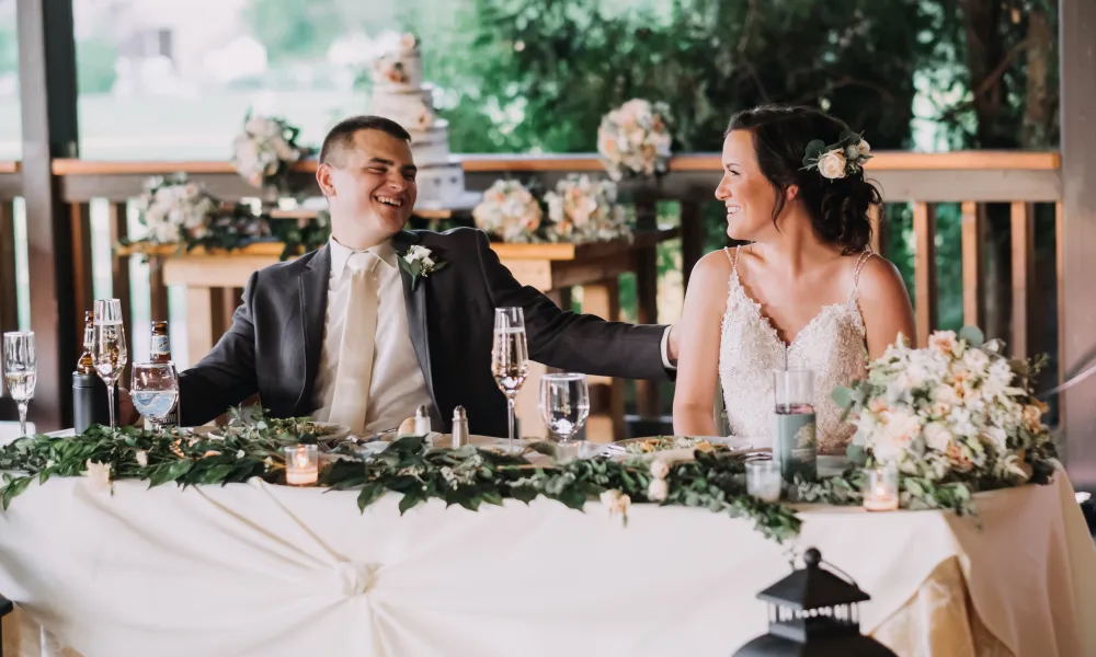 Couple sitting at sweetheart table