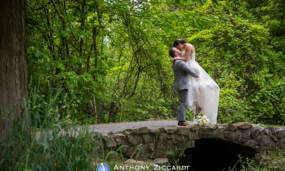 Groom lifting up bride in wedding photo op