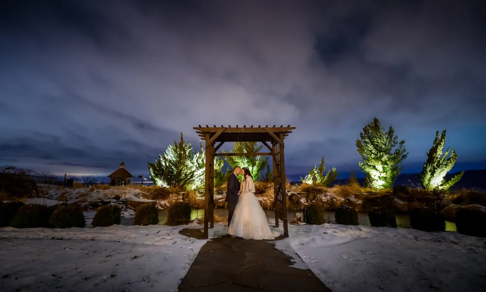 Wedding couple standing under alter at night