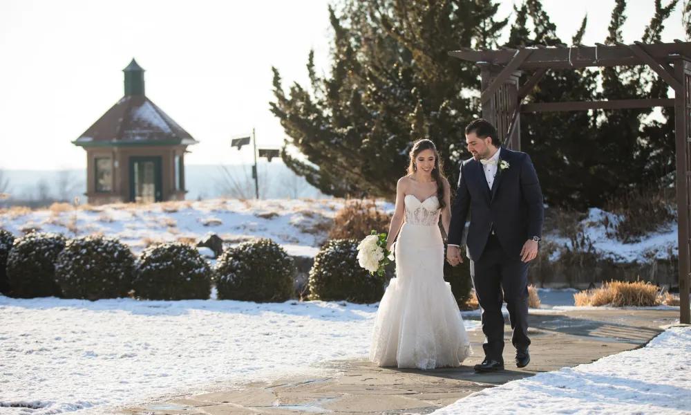 Bride and Groom walking the grounds of Crystal Springs Resort in winter