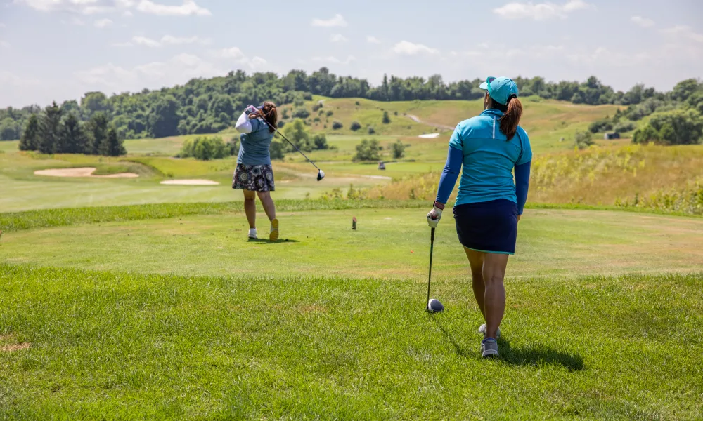 Two women on a golf course at Crystal Springs Resort