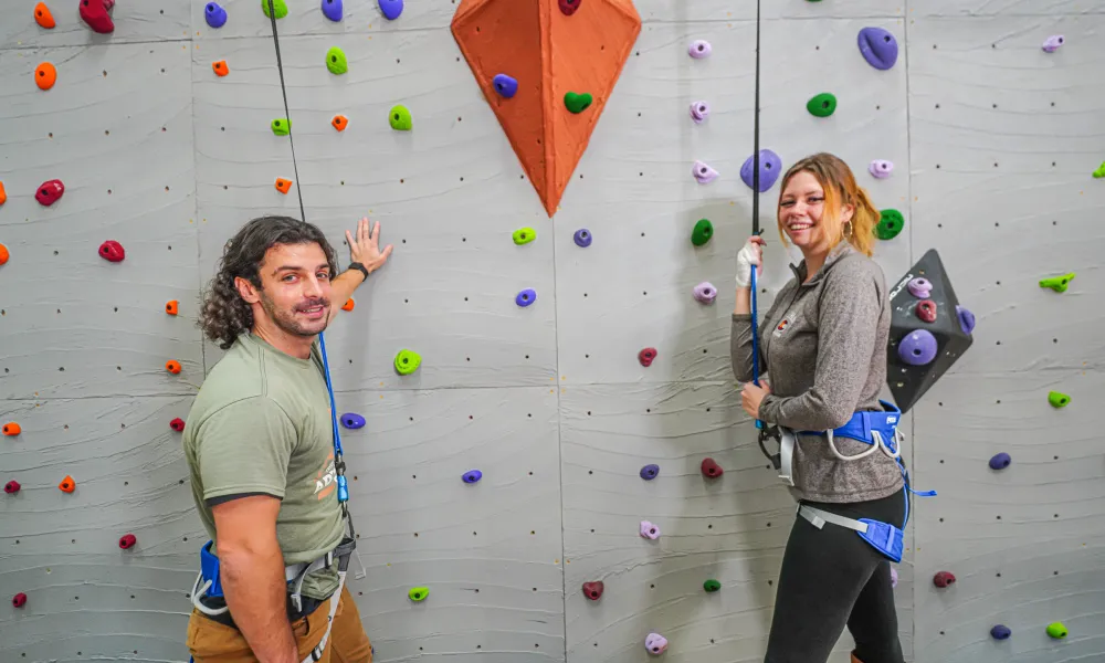 Two adults getting ready to rock climb.