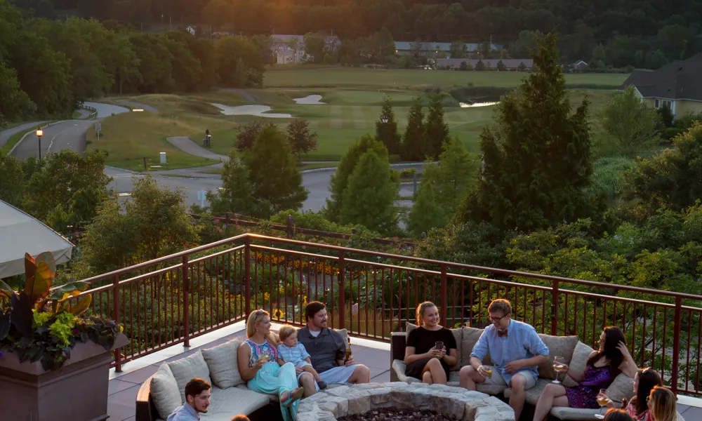 Group hanging out on fire and water terrace at Grand Cascades Lodge