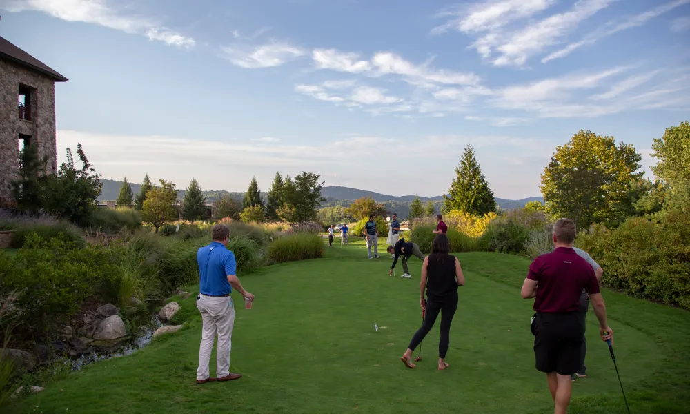 Corporate gatherings putting on the natural grass putting course at a resort close to NYC