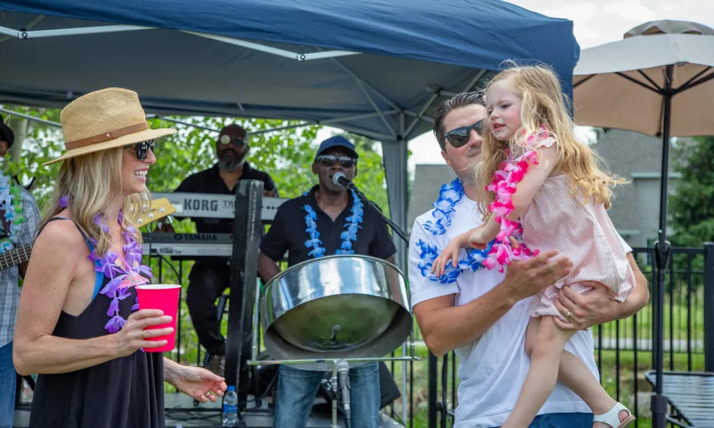 Family dancing to live drum band at Vista Party