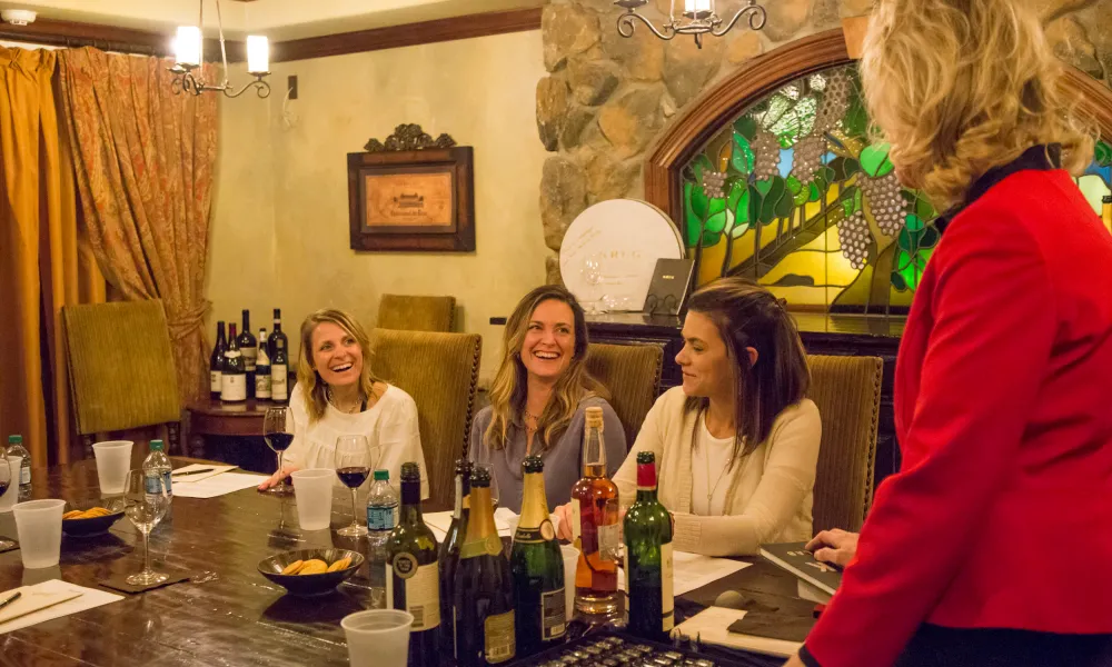 Group of three women do a wine tasting with wine sommelier, Susanne Wagner.