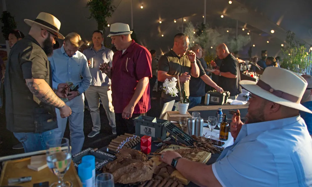 Men wearing Panama hats smoking cigars