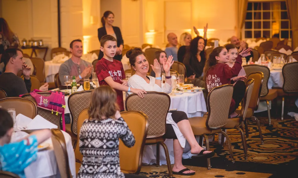 Families enjoying dinner and a show