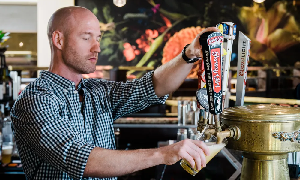 Bartender pouring draft beer at Kites Restaurant