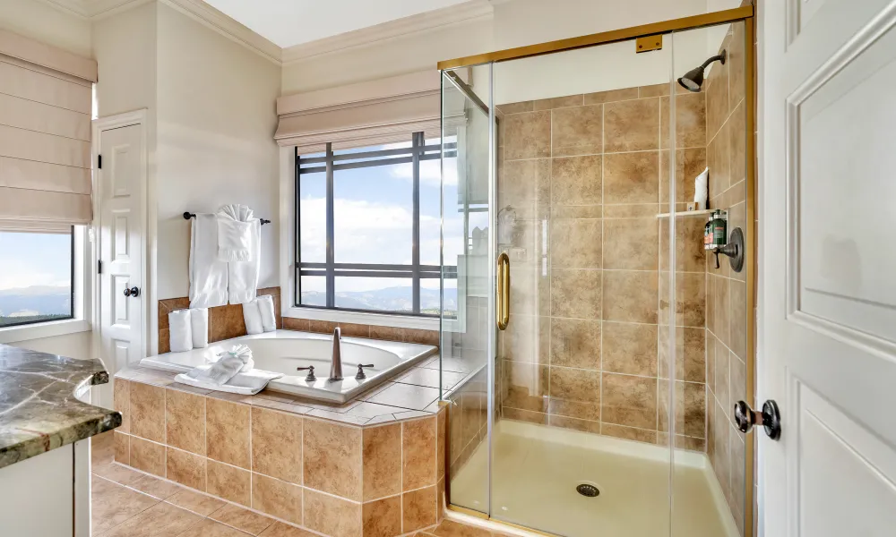 Bathroom with tub and standing shower in the 2 bed 2 bath suite at Grand Cascades Lodge.